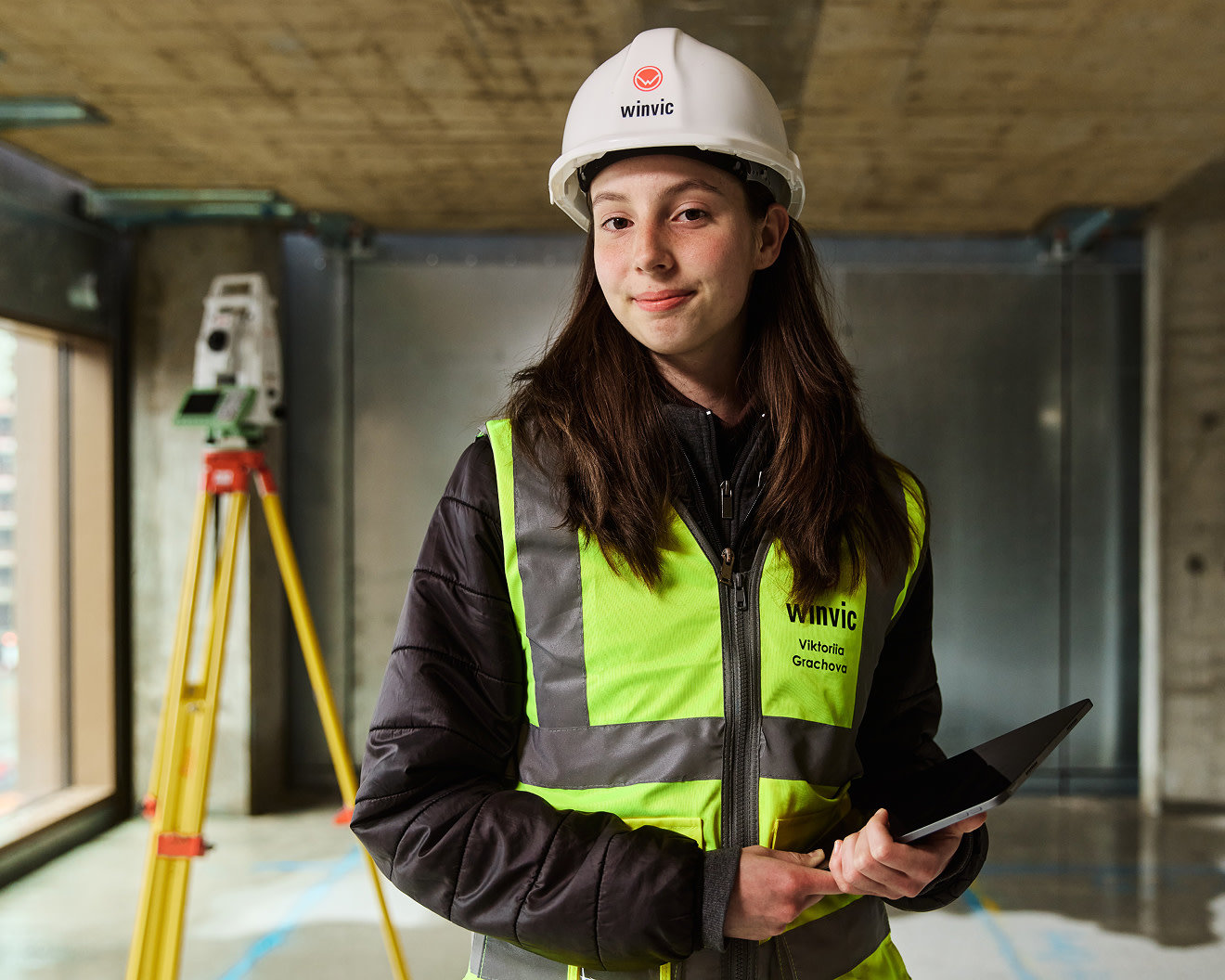 A construction worker using a tablet on site