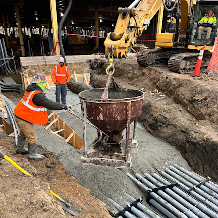 Construction workers pouring down cement