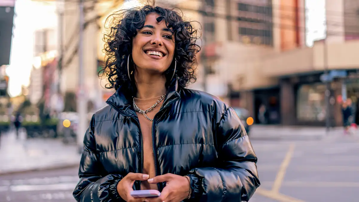An image of a woman holding her phone.