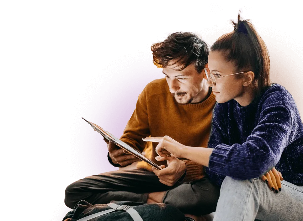 A man and woman looking at a tablet together.