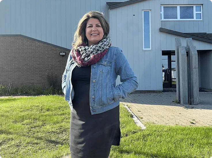 School director Rebecca Nadeau-Monger stands in front of Netagamiou School which benefited from TELUS network investments.
