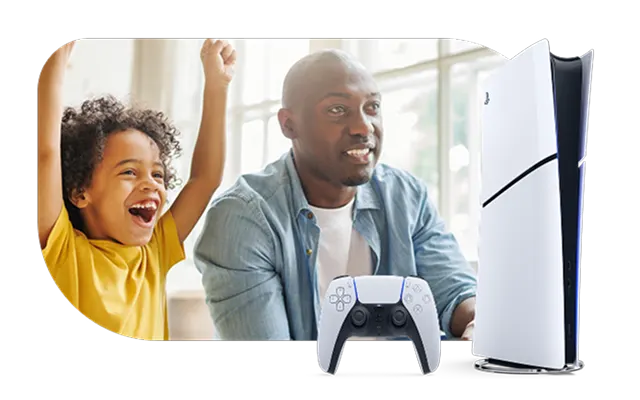 A father and son gaming together. In the bottom right corner is a PlayStation 5 game console and wireless controller.