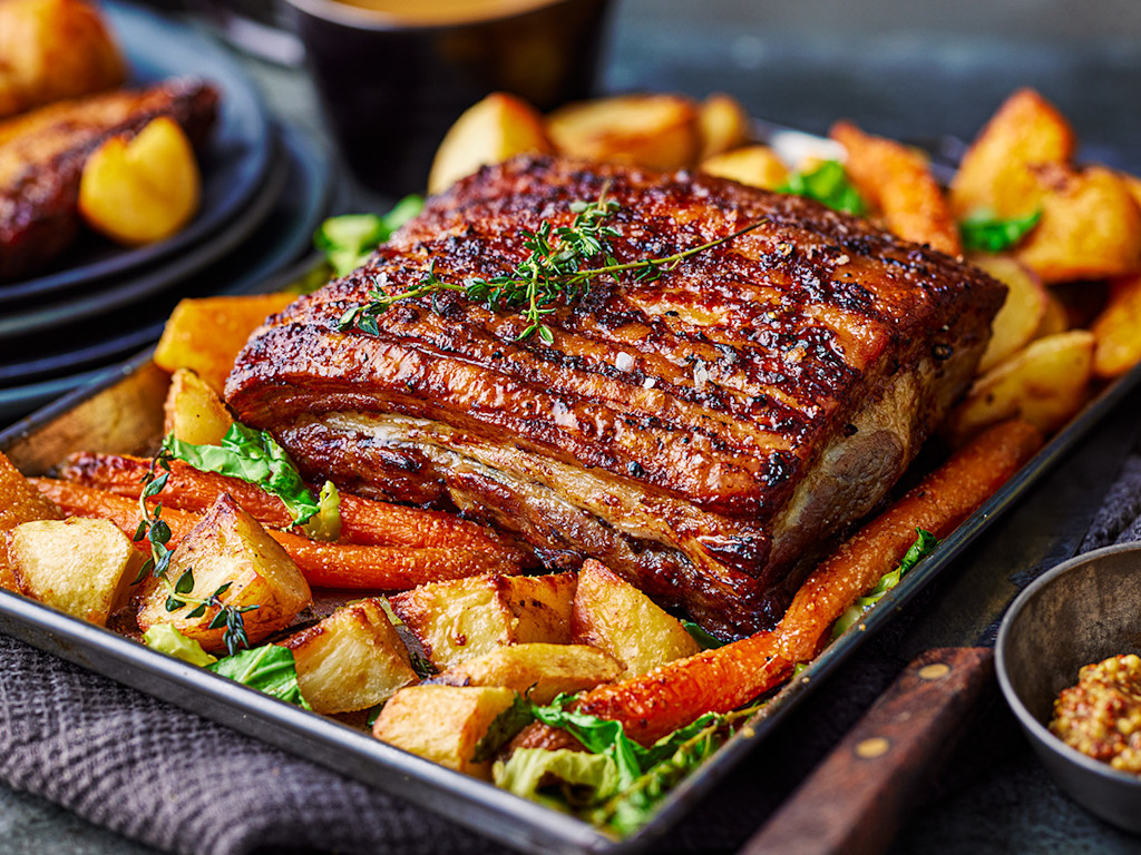 A roast dinner with crispy pork crackling and potatoes