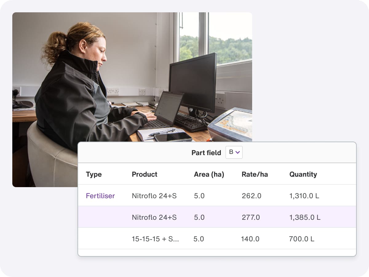 A woman using a computer to check product prices, with crop and farm management software displayed on the screen.